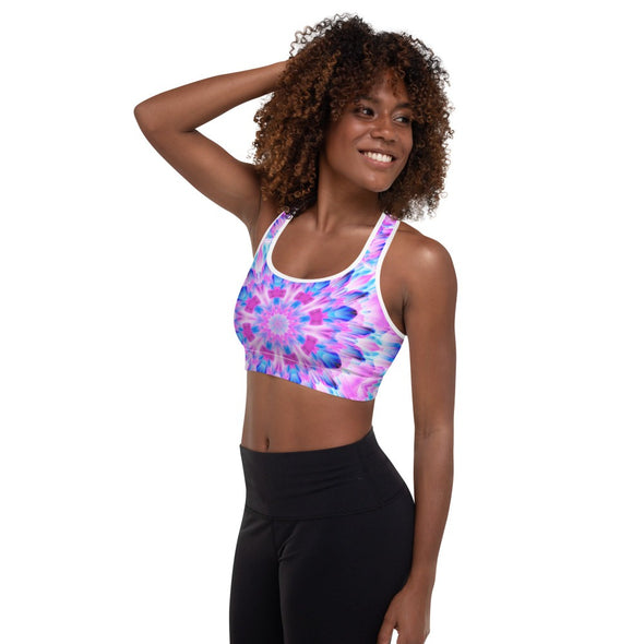 Photograph of a model wearing a Bleace MetaParty Vibes Kaleidoscopic pink, light blue, Trippy Visual sports bra.  