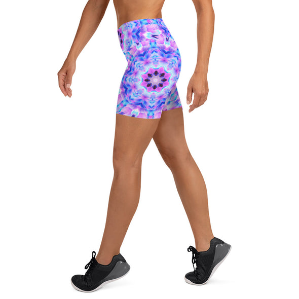 Photograph of a model wearing Bleace unisex MetaParty Vibes Kaleidoscopic pink, light blue, Trippy Visual yoga shorts.  