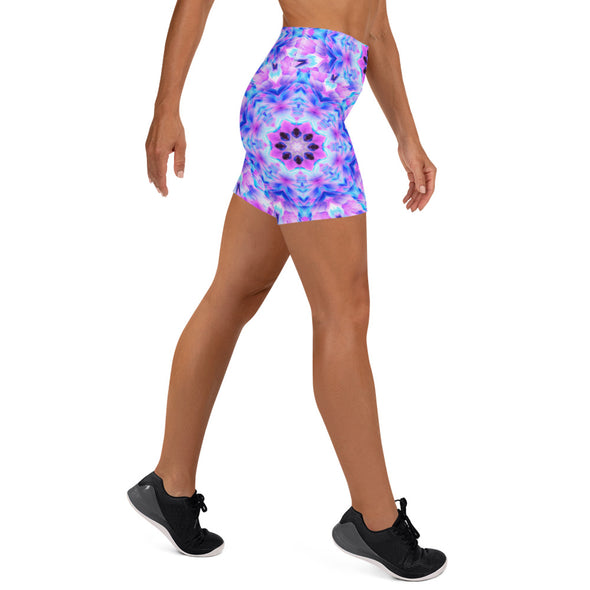 Photograph of a model wearing Bleace unisex MetaParty Vibes Kaleidoscopic pink, light blue, Trippy Visual yoga shorts.  